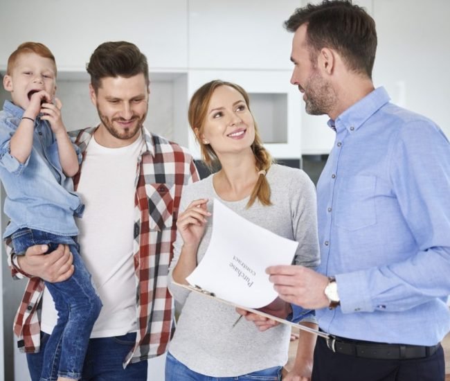 family-and-real-estate-agent-talking-in-new-apartment.jpg